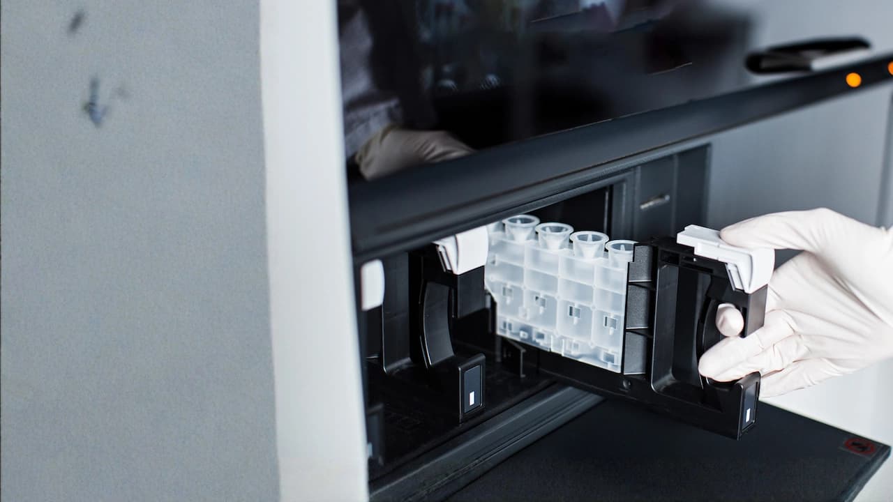 Hands inserting a cartridge into an Alegria Flash instrument - CLIA