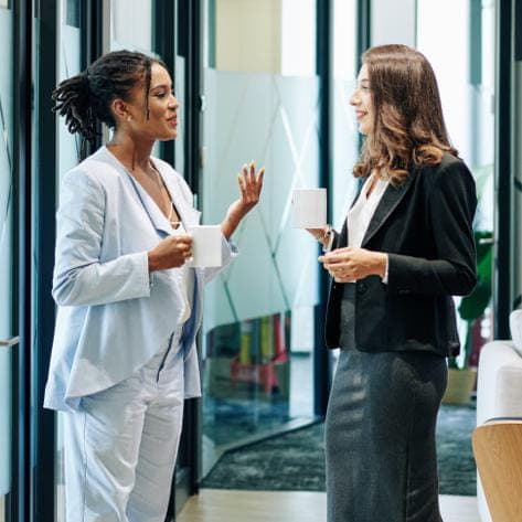 Two women discussing about the Quality and Compliance at Sebia